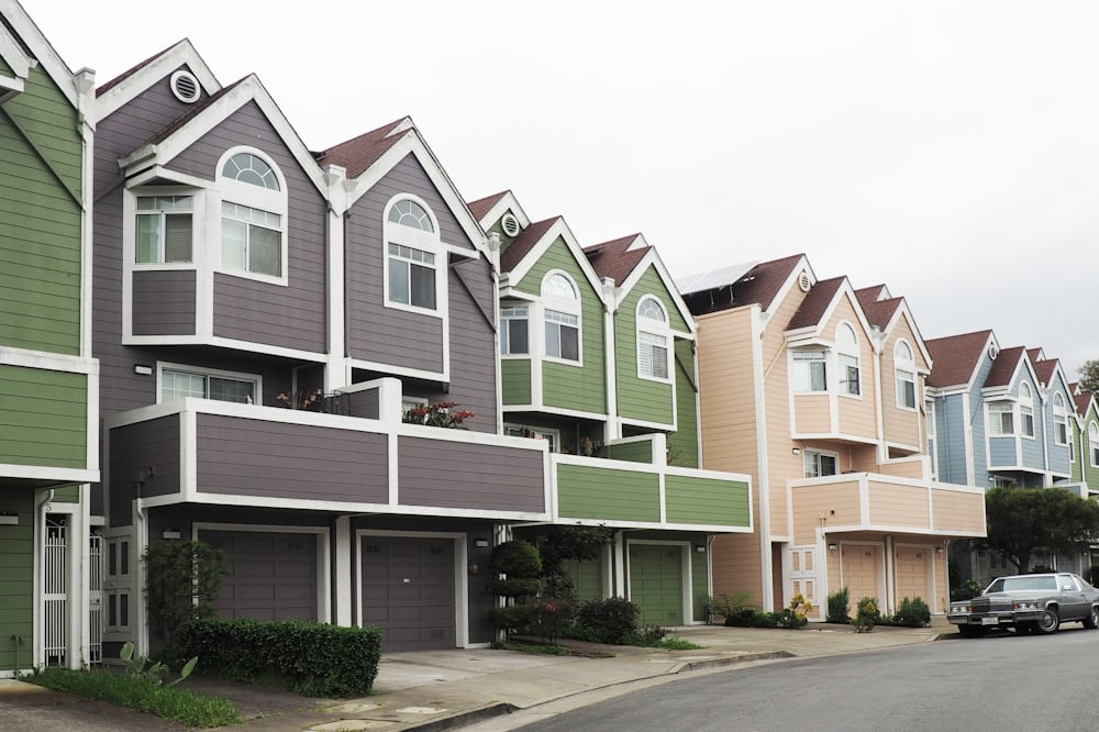 A photo of a row of attached townhomes sharing party walls within a planned-unit-development association.